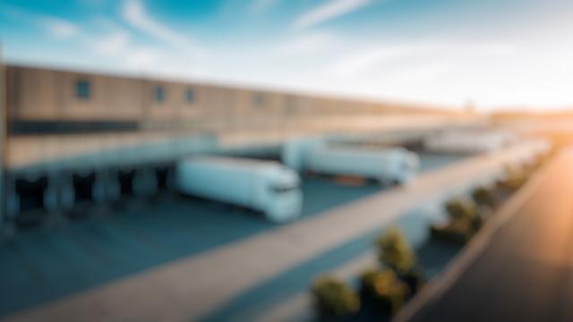 Background: trucks aan dock van warehouse